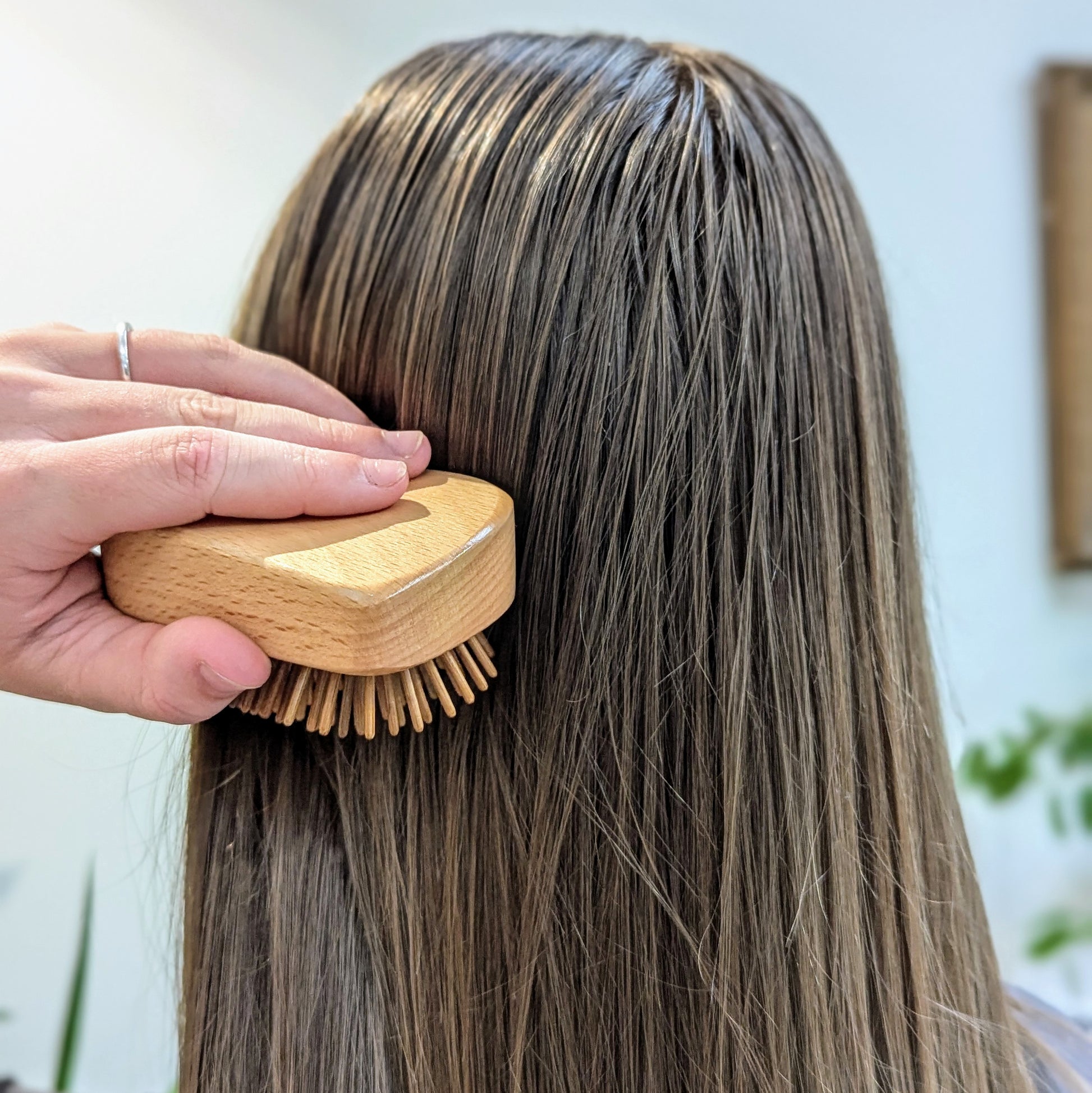 girl brushing hair with Wooden Detangling Brush