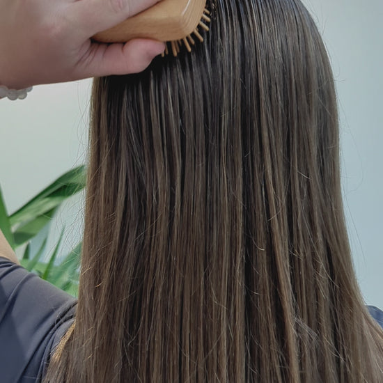 girl brushing hair with Wooden Detangling Brush