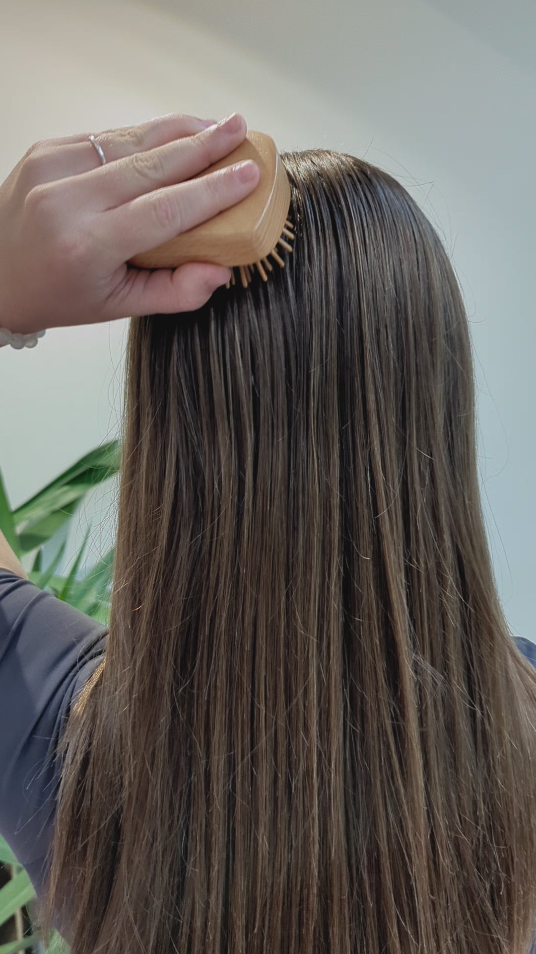 girl brushing hair with Wooden Detangling Brush