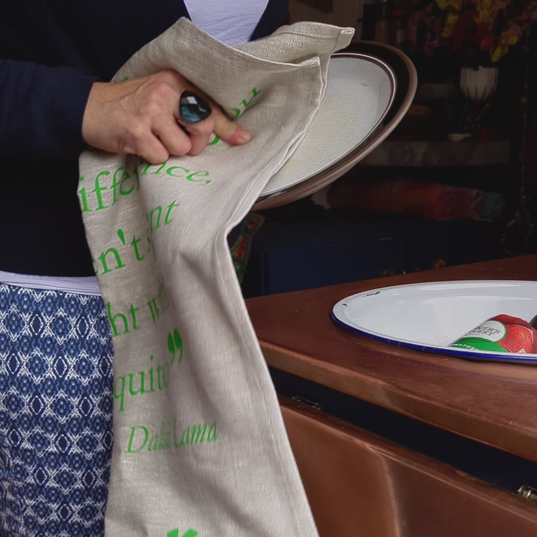 video of woman drying plate with linen tea towel