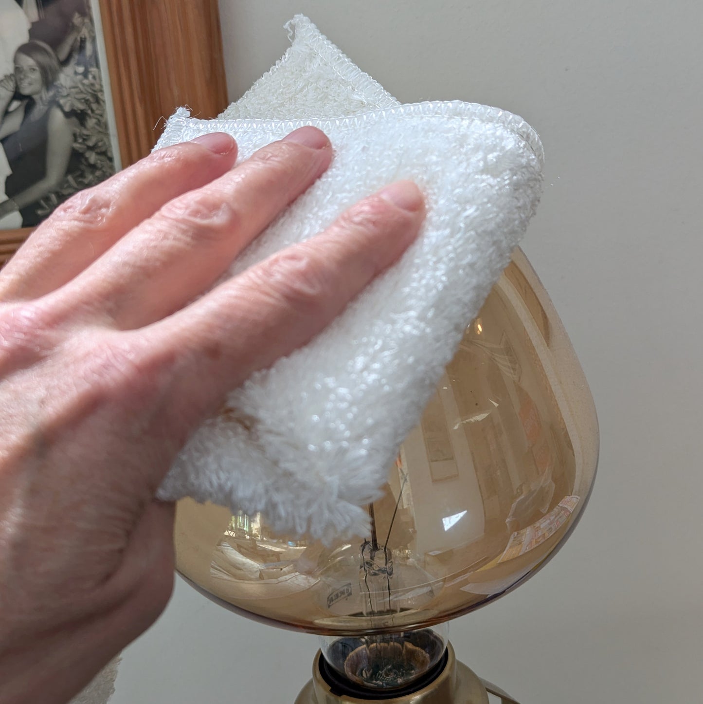 woman wiping glass with white bamboo cloth